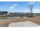 Backyard view of a pond in a neighborhood with houses and lawn at 2472 Campton Loop, Conway, SC 29527