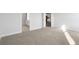 Neutral carpeted bedroom with access to the bathroom and a view to the kitchen at 2472 Campton Loop, Conway, SC 29527