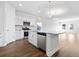 Bright kitchen boasts stainless appliances, granite counters, and an open view to the spacious living area at 2472 Campton Loop, Conway, SC 29527