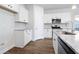 Beautiful kitchen with white cabinetry, granite countertops, stainless steel appliances, and hardwood floors at 2472 Campton Loop, Conway, SC 29527