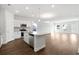 Open-concept kitchen featuring white cabinets, stainless steel appliances, and a spacious island at 2472 Campton Loop, Conway, SC 29527