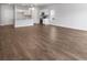 Open-concept living area with hard surface floors, abundant light and adjacent white kitchen at 2472 Campton Loop, Conway, SC 29527