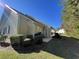 Side view of back patio with furniture set, lush bushes, and outdoor landscaping at 620 Sunnyside Dr. # 102, Murrells Inlet, SC 29576