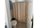 Cozy bathroom featuring a toilet with a shower and neutral-toned curtain at 620 Sunnyside Dr. # 102, Murrells Inlet, SC 29576