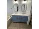 Modern bathroom vanity with double sinks, quartz countertop, and stylish mirrors at 620 Sunnyside Dr. # 102, Murrells Inlet, SC 29576