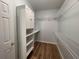 Walk-in closet featuring built-in shelving units and wood-look flooring at 620 Sunnyside Dr. # 102, Murrells Inlet, SC 29576