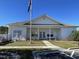 Exterior view of a clubhouse with white siding and a welcoming covered entrance at 620 Sunnyside Dr. # 102, Murrells Inlet, SC 29576