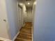 Neutral colored hallway with wood look floors leading to rooms in the home at 620 Sunnyside Dr. # 102, Murrells Inlet, SC 29576