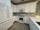 Modern kitchen with white cabinets, stainless steel appliances, and tile backsplash at 620 Sunnyside Dr. # 102, Murrells Inlet, SC 29576