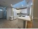 Bright kitchen with white cabinets, quartz countertop, stainless appliances, and skylight at 620 Sunnyside Dr. # 102, Murrells Inlet, SC 29576