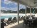 Community pool deck with lounge chairs and patio tables under a covered area at 620 Sunnyside Dr. # 102, Murrells Inlet, SC 29576