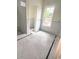 Bright bathroom with white subway tiled shower, classic black and white mosaic flooring, and a large window for natural light at 314 Hollywood Dr. S, Surfside Beach, SC 29575