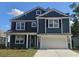 Charming two-story home with a blue shingle exterior, white trim, black shutters and an attached two-car garage at 694 Choctaw Dr., Conway, SC 29526
