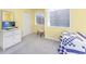Bedroom featuring bright yellow walls, carpet, and a large window at 86 Shadow Moss Pl. # 86, North Myrtle Beach, SC 29582