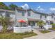 Charming two-story townhome with a cozy front patio and well-maintained landscaping, offering a welcoming curb appeal at 86 Shadow Moss Pl. # 86, North Myrtle Beach, SC 29582