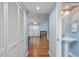 Inviting hallway with hardwood floors leading to a living room with a fireplace and a convenient powder room at 86 Shadow Moss Pl. # 86, North Myrtle Beach, SC 29582
