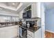 Updated kitchen features granite countertops, white cabinets, and stainless microwave at 86 Shadow Moss Pl. # 86, North Myrtle Beach, SC 29582