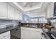 Bright kitchen with granite counters, stainless sink, and gray tile backsplash at 86 Shadow Moss Pl. # 86, North Myrtle Beach, SC 29582