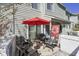 Cozy patio with comfortable seating, a bright red umbrella, and a privacy wall, perfect for outdoor relaxation at 86 Shadow Moss Pl. # 86, North Myrtle Beach, SC 29582