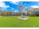 Well-maintained lawn with a patio and a fire pit perfect for outdoor entertaining at 865 River Rd., Tabor City, NC 28463