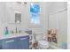 Updated bathroom featuring navy blue vanity and a step-in shower with glass door at 865 River Rd., Tabor City, NC 28463