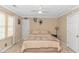 Cozy bedroom featuring a queen sized bed, ceiling fan, and light tan colored walls at 865 River Rd., Tabor City, NC 28463