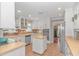 Bright kitchen with white cabinetry, an island, stainless steel appliances, and tile floors at 865 River Rd., Tabor City, NC 28463