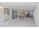 Spacious covered porch with white wood floors, lots of windows and space for entertaining at 865 River Rd., Tabor City, NC 28463