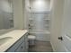 Clean, well-lit bathroom featuring a shower-tub combo and a gray vanity with a white countertop at 1044 Jase Dr., Longs, SC 29568