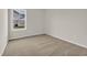 Cozy bedroom with plush carpeting and a bright window overlooking the lawn at 1044 Jase Dr., Longs, SC 29568
