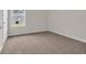 Empty room featuring neutral walls, soft carpet, and a bright window; ideal for relaxation and personalization at 1044 Jase Dr., Longs, SC 29568