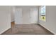 Bright bedroom with neutral walls, carpet, large window, and a closet and bedroom entrance at 1044 Jase Dr., Longs, SC 29568