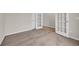 Empty bedroom shows soft carpet with glass-paned French door and white door to the side at 1044 Jase Dr., Longs, SC 29568