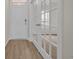 The entryway boasts wood-look floors, a door, and a view of another room through glass french doors at 1044 Jase Dr., Longs, SC 29568