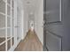 Inviting hallway features wood-look floors and glass paneled doors leading to additional rooms at 1044 Jase Dr., Longs, SC 29568