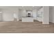 Open floor plan featuring wood-look flooring, a granite island, and white cabinets at 1044 Jase Dr., Longs, SC 29568