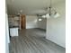 Bright open-concept living room featuring modern gray flooring, chandelier, and recessed lighting at 1044 Jase Dr., Longs, SC 29568