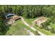 Aerial view of equestrian facilities, including stables, an arena, and vast green pastures, ideal for horse enthusiasts at 1692 S Morgan Ave., Andrews, SC 29510