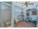 Bright bathroom with vinyl floors, shower, sink, toilet, a storage bench, and many unique decorations at 1692 S Morgan Ave., Andrews, SC 29510