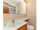 Cozy bathroom featuring a shower, toilet, sink and mirror with warm neutral walls at 1692 S Morgan Ave., Andrews, SC 29510