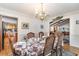 Formal dining room with a chandelier and views into the kitchen and living room at 1692 S Morgan Ave., Andrews, SC 29510