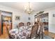 Formal dining room with a chandelier and seating for six next to the kitchen at 1692 S Morgan Ave., Andrews, SC 29510