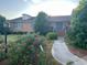 Charming brick home with a welcoming entrance and blue shutters framed by mature landscaping at 1692 S Morgan Ave., Andrews, SC 29510