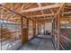 Rustic horse stalls featuring wood construction, metal gates, and overhead lighting, offering safe and comfortable housing at 1692 S Morgan Ave., Andrews, SC 29510