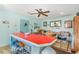 Spacious living room featuring a built-in bar area with red countertop, a table, and vintage decorations at 1692 S Morgan Ave., Andrews, SC 29510