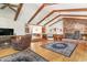 Spacious living room features a brick fireplace, wood beams, and hardwood floors at 1692 S Morgan Ave., Andrews, SC 29510