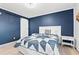 Cozy bedroom featuring a bed with a star-patterned quilt and navy blue accent wall at 191 Maison Dr. # B203, Myrtle Beach, SC 29572