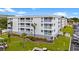 Multi-story condo building featuring balconies, well-maintained landscaping, and ample parking at 191 Maison Dr. # B203, Myrtle Beach, SC 29572