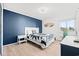 Comfortable main bedroom with wood accent wall, queen bed, and ample light at 191 Maison Dr. # B203, Myrtle Beach, SC 29572