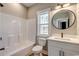 Bright bathroom with white fixtures, modern lighting, and a window at 217 Shady Pines Ct., Conway, SC 29527